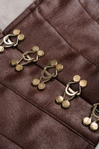 Close-up of a brown fabric with gold buttons on a gray background